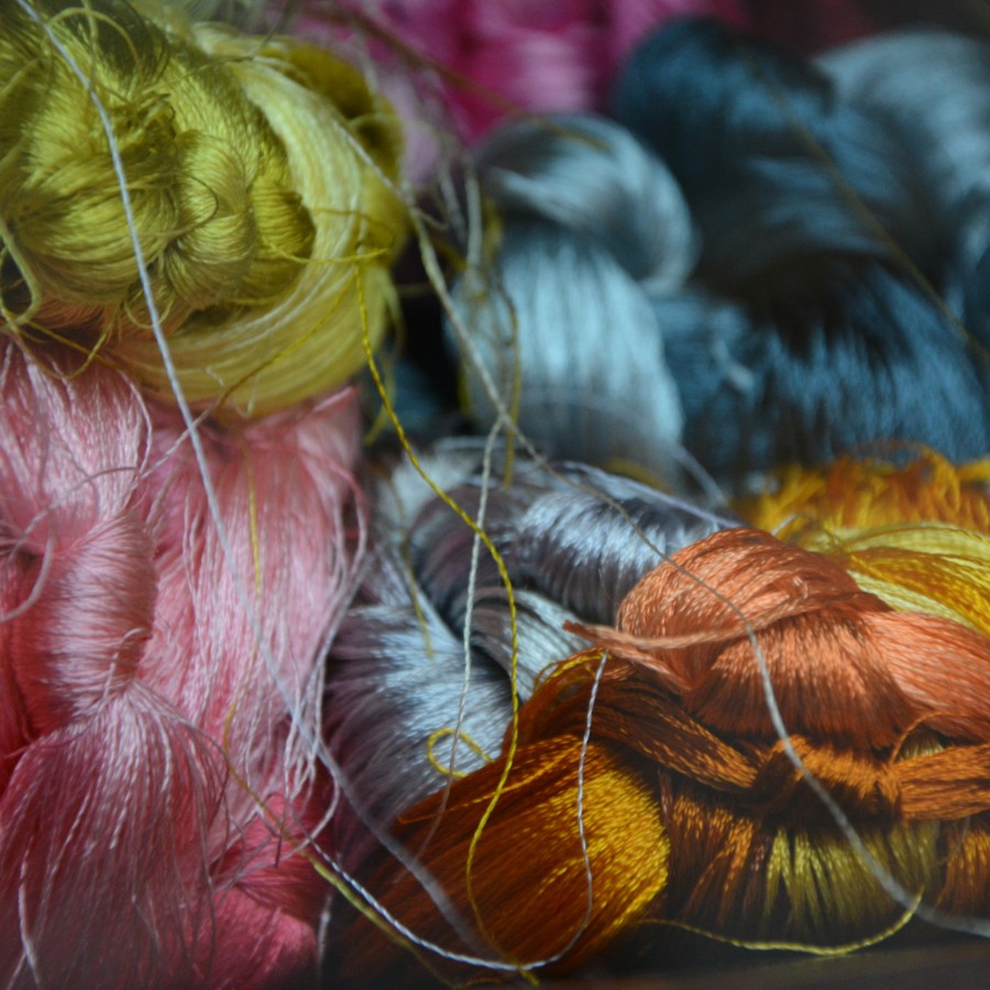 colourful pile of embroidery thread by beth-macdonald-o7Zv2-7xpNM-unsplash